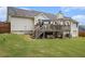 An exterior view of a home with a deck, showcasing the well-maintained lawn and expansive backyard at 1250 Timber Walk Dr, Loganville, GA 30052