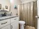 Bathroom features a vanity with granite countertop and a shower with curtain at 1250 Timber Walk Dr, Loganville, GA 30052