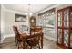 Traditional dining room with wood table set for six, complemented by a charming china cabinet at 1250 Timber Walk Dr, Loganville, GA 30052