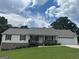 Charming single-story home featuring a welcoming front porch, well-maintained lawn, and an attached two-car garage at 1250 Timber Walk Dr, Loganville, GA 30052