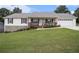 Charming single-story home featuring a welcoming front porch and well-manicured lawn at 1250 Timber Walk Dr, Loganville, GA 30052