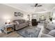 Living room featuring wood flooring, large windows, and an open layout with comfortable furniture at 1250 Timber Walk Dr, Loganville, GA 30052
