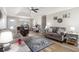Cozy living room featuring vaulted ceiling, ceiling fan, plush furniture, and a beautiful area rug at 1250 Timber Walk Dr, Loganville, GA 30052