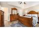 Bright main bedroom featuring a trey ceiling, fan, and wood furniture at 1250 Timber Walk Dr, Loganville, GA 30052