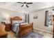 Serene main bedroom featuring a trey ceiling, fan, and wood furniture at 1250 Timber Walk Dr, Loganville, GA 30052
