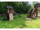 Backyard featuring wooden playset with slide, rock climbing wall and steps at 19 Autumn Ne Pl, White, GA 30184