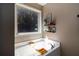 Bathtub with a large window, decorative shelves, and natural light at 19 Autumn Ne Pl, White, GA 30184