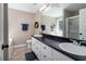 Bathroom with double vanity, white cabinets, and a shower/tub combo at 19 Autumn Ne Pl, White, GA 30184