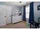 Bright bedroom featuring blue walls, a white dresser, and dark blue curtains at 19 Autumn Ne Pl, White, GA 30184