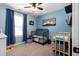 Cozy bedroom with blue walls, modern ceiling fan, and lots of natural light at 19 Autumn Ne Pl, White, GA 30184