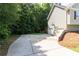 Large driveway leading to a two-car garage, surrounded by mature trees and well-kept lawn at 19 Autumn Ne Pl, White, GA 30184