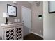 Inviting foyer with decorative cabinet, neutral paint, and a sleek, white door at 19 Autumn Ne Pl, White, GA 30184
