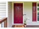 Close-up of the front door with vibrant shutters, potted plants, and a welcoming doormat at 19 Autumn Ne Pl, White, GA 30184