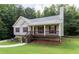 Charming single-story home with a well-maintained lawn, inviting porch, and colorful landscaping at 19 Autumn Ne Pl, White, GA 30184