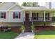Inviting front porch with classic railings, colorful shutters, and a well-manicured lawn at 19 Autumn Ne Pl, White, GA 30184