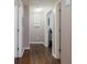 Hallway with hardwood floors, white trim, and doors leading to other rooms at 19 Autumn Ne Pl, White, GA 30184