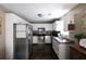 Well-lit kitchen featuring white cabinets, stainless steel appliances, and dark countertops at 19 Autumn Ne Pl, White, GA 30184