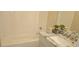 Bathroom featuring a tub with white subway tile surround, granite countertop vanity, and modern fixtures at 2085 Dellwood, Decatur, GA 30032