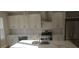 Modern kitchen featuring an island, stainless steel appliances, and white cabinetry at 2085 Dellwood, Decatur, GA 30032