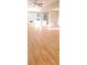 Sunlit living room with hardwood floors flowing into a modern kitchen featuring white cabinets and stainless appliances at 2085 Dellwood, Decatur, GA 30032