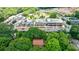 Aerial view of a commercial real estate location with nearby park and a home covered by trees at 27 S Avondale Rd, Avondale Estates, GA 30002