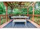Beautiful back deck with a wooden pergola, outdoor seating, and ceiling fan, perfect for relaxing and entertaining at 27 S Avondale Rd, Avondale Estates, GA 30002