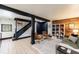 Finished basement features tile floors, black trim and a cozy lounge area at 27 S Avondale Rd, Avondale Estates, GA 30002