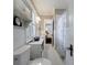 Bright white bathroom with beadboard walls, hexagon tile flooring, and a view into the main bedroom at 27 S Avondale Rd, Avondale Estates, GA 30002