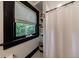 Bathroom featuring a shower and a window with a roller shade overlooking a tree at 27 S Avondale Rd, Avondale Estates, GA 30002