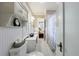 Classic white bathroom with beadboard walls, hexagon tile flooring, and view into the main bedroom at 27 S Avondale Rd, Avondale Estates, GA 30002
