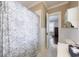 Cozy bathroom featuring a shower with a floral curtain, and white wainscoting, creating a serene space at 27 S Avondale Rd, Avondale Estates, GA 30002