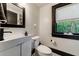 Stylish bathroom with a modern sink, toilet, window, and black trim at 27 S Avondale Rd, Avondale Estates, GA 30002