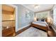 Charming bedroom featuring hardwood floors, a ceiling fan, and a double-hung window with white shutters at 27 S Avondale Rd, Avondale Estates, GA 30002