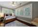 Bright bedroom with large windows, white shutters, wood floors, and a comfortable bed with stylish pillows at 27 S Avondale Rd, Avondale Estates, GA 30002