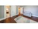 Relaxing bedroom featuring hardwood floors, three doors, and a comfortable gray sofa at 27 S Avondale Rd, Avondale Estates, GA 30002