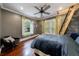 Cozy bedroom with hardwood floors, a ladder to an upper space, a ceiling fan and ample natural light at 27 S Avondale Rd, Avondale Estates, GA 30002