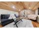 Charming bonus room with a vaulted wood ceiling, brick wall, and cozy seating area, perfect for relaxation at 27 S Avondale Rd, Avondale Estates, GA 30002