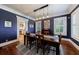Sophisticated dining room with dark blue walls, plantation shutters, and a striking lighting fixture at 27 S Avondale Rd, Avondale Estates, GA 30002