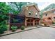 Charming brick house features a covered porch, 2-car garage and landscaped yard at 27 S Avondale Rd, Avondale Estates, GA 30002