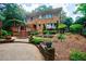 Stately brick home with a well-maintained landscape, patio, and multi-level outdoor living spaces at 27 S Avondale Rd, Avondale Estates, GA 30002
