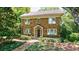 Brick home with lovely landscaping, a cozy front porch, and traditional design elements at 27 S Avondale Rd, Avondale Estates, GA 30002