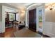Bright foyer with hardwood floors, decorative trim, and a view into the adjacent dining room at 27 S Avondale Rd, Avondale Estates, GA 30002
