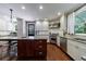 Modern kitchen with stainless steel appliances, white cabinetry, granite countertops, and a wooden central island at 27 S Avondale Rd, Avondale Estates, GA 30002