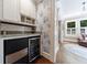 Kitchen featuring an ice maker, wine cooler, white cabinets, granite countertops, and hardwood flooring at 27 S Avondale Rd, Avondale Estates, GA 30002