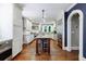 Bright kitchen with white cabinets, granite countertops, stainless steel appliances, and a center island at 27 S Avondale Rd, Avondale Estates, GA 30002