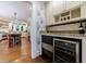 Open kitchen featuring an ice maker, wine cooler, white cabinets, and hardwood flooring at 27 S Avondale Rd, Avondale Estates, GA 30002