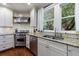 Well-lit kitchen features stainless steel appliances, granite countertops, subway tile backsplash, and natural light at 27 S Avondale Rd, Avondale Estates, GA 30002