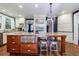 Bright kitchen with stainless steel appliances, granite countertops, white cabinets, and a central island with seating at 27 S Avondale Rd, Avondale Estates, GA 30002