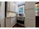 Kitchen view with stainless steel oven, microwave, white cabinets, granite countertops, and subway tile backsplash at 27 S Avondale Rd, Avondale Estates, GA 30002