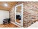 Unique living room with exposed brick accent wall and a lighted mirror at 27 S Avondale Rd, Avondale Estates, GA 30002